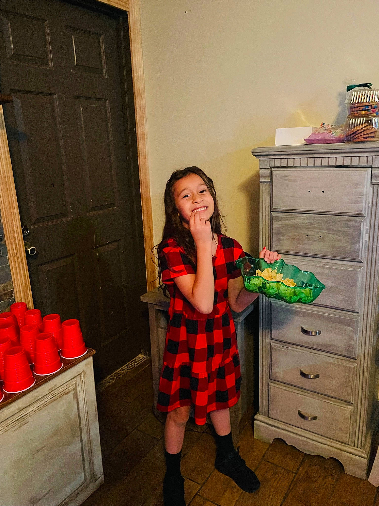 Aleynah is registered to the contest to win money with this photo: cabinetry, chest_of_drawers, door, drawer, dress, flooring, glasses, home_appliance, human_body, interior_design, joy, leg, orange, person, pink, plaid, red, tartan, thigh, waist