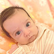 Alaina joined the competition — help win amazing prizes! baby, infant, face, eyes, expression, clothing, striped, blanket, soft, cute, portrait, newborn, skin, head, young, person, indoors, closeup, laying, warm_colors