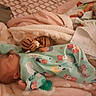 Zariah is registered to the contest to win money with this photo: baby, newborn, sleeping, blanket, pajamas, stuffed_toy, pacifier, bed, soft, cozy, infant, child, sleep, comfort, patterned_fabric, pink, green, animal_print, indoors, rest