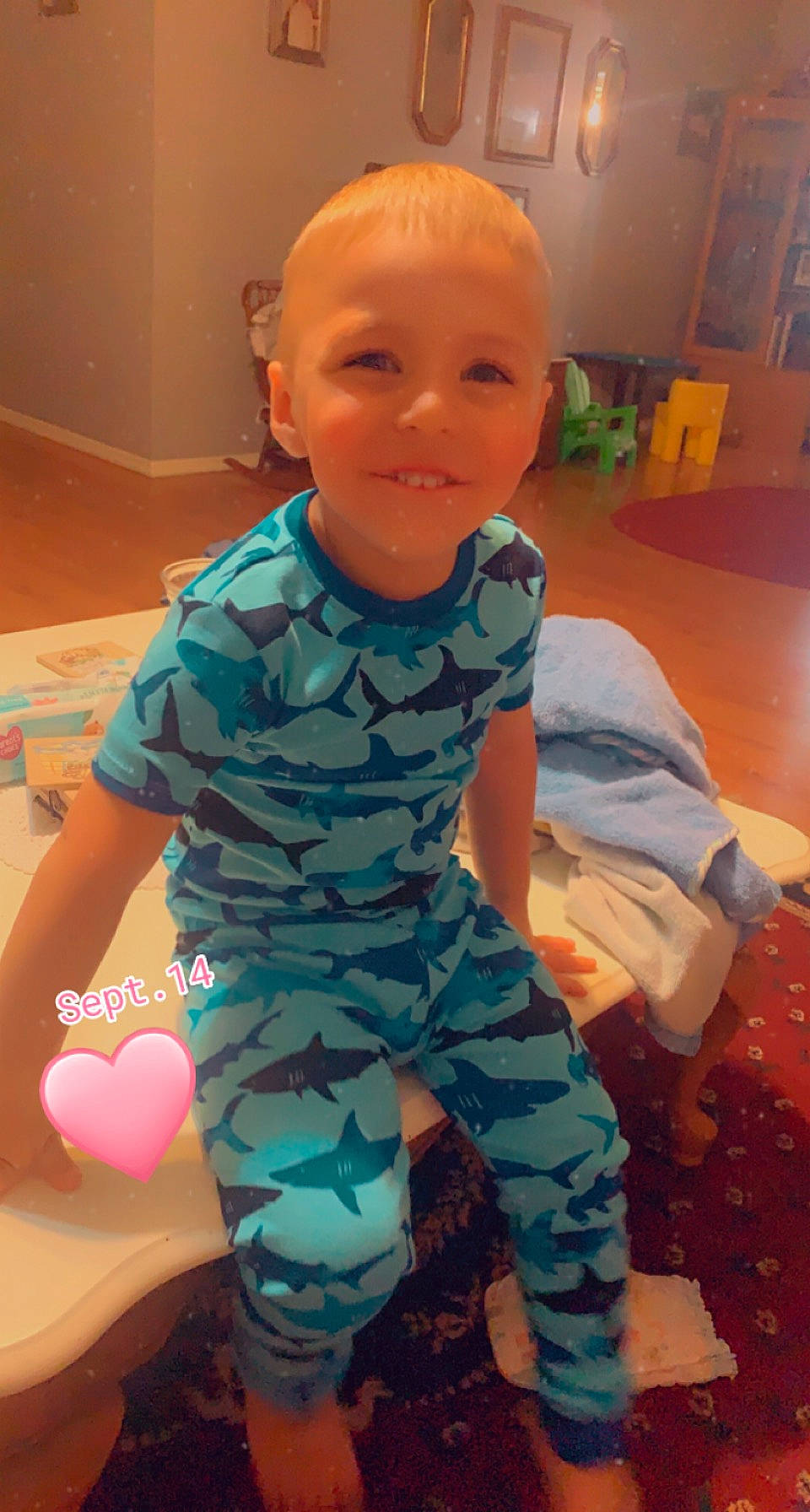 Benjamin is registered to the contest to win money with this photo: baby, baby_toddler_clothing, camouflage, child, facial_expression, flooring, fun, hairstyle, happy, human_body, human_leg, joy, military_camouflage, pajamas, pattern, person, play, sitting, sleeve, smile