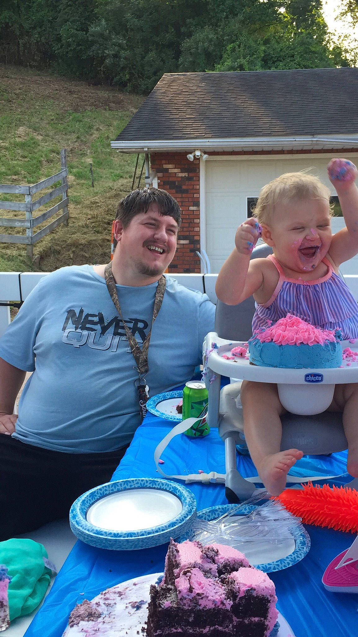 Flora is registered to the contest to win money with this photo: blue, community, cooking, event, food, fun, grass, green, happy, joy, leisure, person, pink, plate, recreation, shorts, smile, summer, t_shirt, table