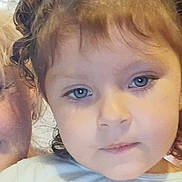 Emberlee Clements is registered to the contest to win money with this photo: child, face, portrait, curly_hair, blue_eyes, shirt, cartoon, indoor, curtain, person, young, hair_buns, closeup, expression, casual_clothing, human, cute, childhood, smile, eyelashes