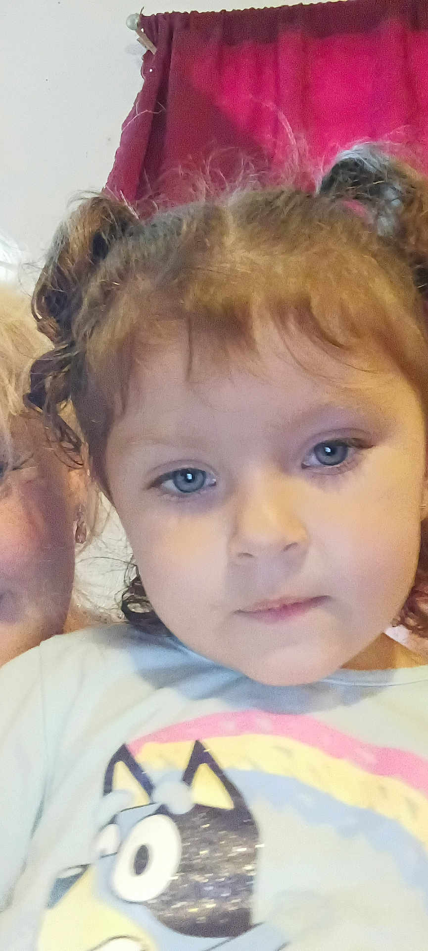 Emberlee Clements is registered to the contest to win money with this photo: child, face, portrait, curly_hair, blue_eyes, shirt, cartoon, indoor, curtain, person, young, hair_buns, closeup, expression, casual_clothing, human, cute, childhood, smile, eyelashes