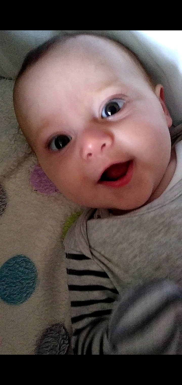 Arthur is registered to the contest to win money with this photo: baby, baby_toddler_clothing, cheek, close_up, comfort, eye, eyebrow, eyelash, fun, happy, iris, lip, mouth, neck, nose, person, pink, skin, sleeve, smile