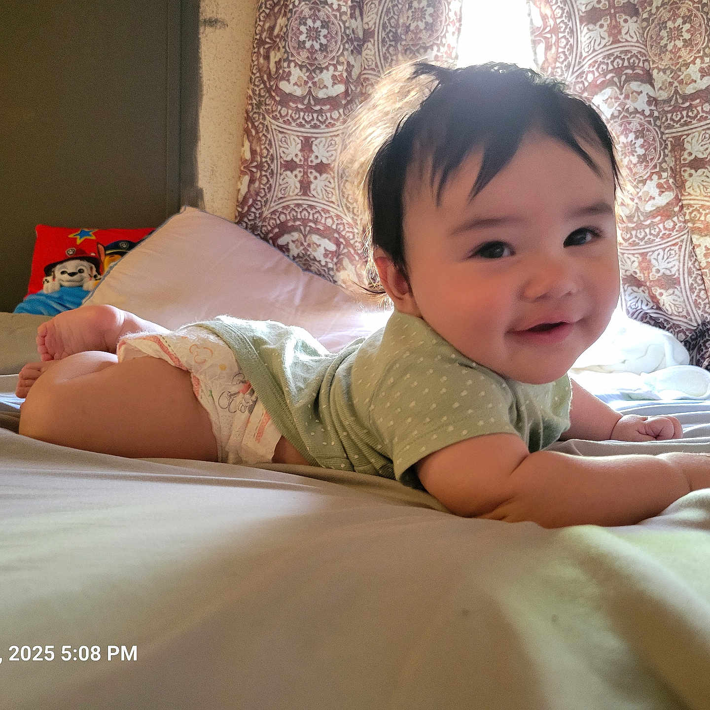 Kaedyn is registered to the contest to win money with this photo: baby, bed, bedroom, bodypart, couch, cushion, diaper, face, finger, furniture, hand, happy, head, homedecor, indoors, person, photography, portrait, room, smile