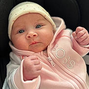 Paola participe au concours pour gagner de l'argent avec cette photo : baby, infant, face, hat, hoodie, pink_clothing, fist, cute, child, portrait, closeup, person, newborn, expression, apparel, casual_clothing, warm_clothing, indoor, soft_lighting, young_child