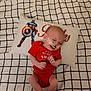 Colton Michael joined the competition — help win amazing prizes! baby, infant, red_onesie, medical_tape, face, pillow, captain_america, bedspread, checkered_pattern, lying_down, small_hands, tiny_feet, indoor, child, person, cute, resting, patriotic, celebration, home