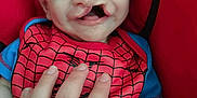 Colton Michael joined the competition — help win amazing prizes! baby, child, cleft_lip, red, blue, spiderman, bib, hand, seat, infant, close_up, smiling, person, cute, portrait, young, indoor, clothing, human, face