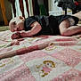 Colton Michael joined the competition — help win amazing prizes! baby, infant, child, quilt, blanket, pattern, animal_print, indoor, carpet, furniture, floor, person, clothing, black_shirt, skin, head, arms, legs, resting, curious