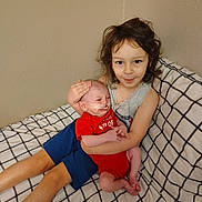 Colton Michael is registered to the contest to win money with this photo: child, baby, bed, blanket, checkered, couch, face, family, gentle, holding, infant, indoors, love, newborn, person, portrait, resting, smile, toddler, young