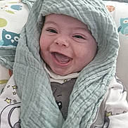 Micky joined the competition — help win amazing prizes! baby, smiling, face, child, cloth, blanket, cozy, pattern, owl, happy, cute, infant, fabric, portrait, indoors, apparel, head_covering, closeup, expression, comfort