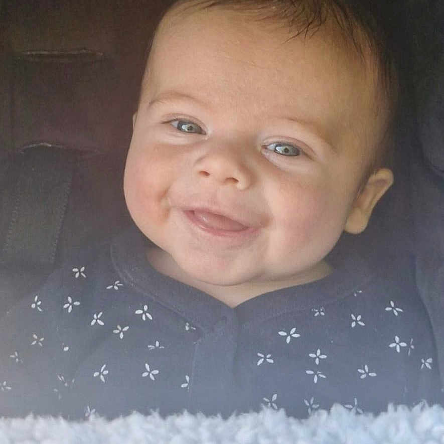 Micky is registered to the contest to win money with this photo: baby, baby_girl_or_boy, blanket, blue_eyes, car_seat, child, closeup, clothing, cute, expression, face, happy, indoors, infant, portrait, seat, skin, smiling, soft_texture, young