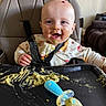 Stetson joined the competition — help win amazing prizes! baby, high_chair, food, messy, smiling, face, spoon, feeding, child, indoor, clothing, happy, baby_food, tray, hand, head, person, mouth_open, seat, cooking