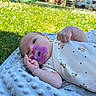 baby, pacifier, blanket, grass, outdoor, sunlight, playground, slide, infant, child, clothing, blue, green, nature, toy, cute, person, soft, relaxing, daytime