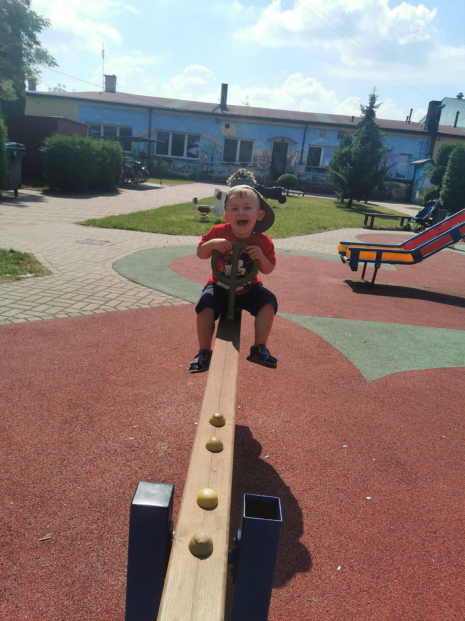Alan joined the competition — help win amazing prizes! asphalt, baby, city, cloud, fun, grass, hat, leisure, musical_instrument, person, plant, playground, playground_slide, public_space, recreation, road_surface, sitting, sky, toddler, tree