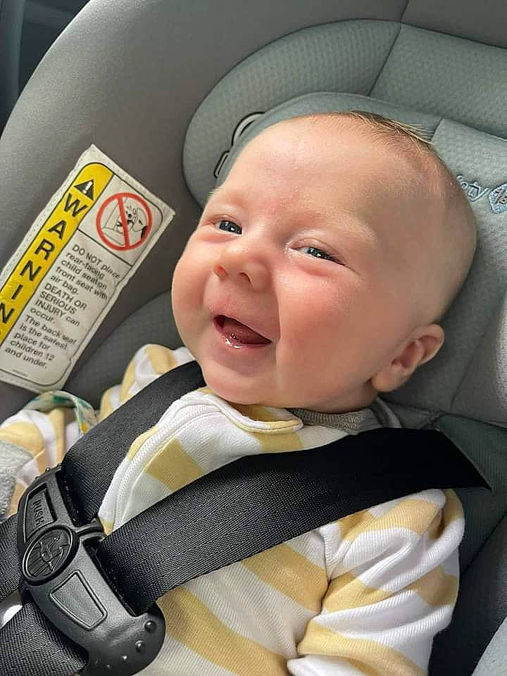 Micheal is registered to the contest to win money with this photo: auto_part, baby, baby_carriage, baby_in_car_seat, baby_products, baby_safety, baby_toddler_clothing, car_seat, cheek, child, comfort, fashion_accessory, happy, hat, person, product, service, skin, smile, thumb