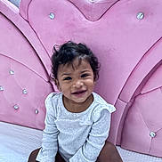 Zamira joined the competition — help win amazing prizes! toddler, child, smiling, sitting, portrait, indoors, pink, chair, upholstery, sparkles, gray_clothing, long_sleeves, curly_hair, earrings, happy, baby, furniture, home, closeup, photography