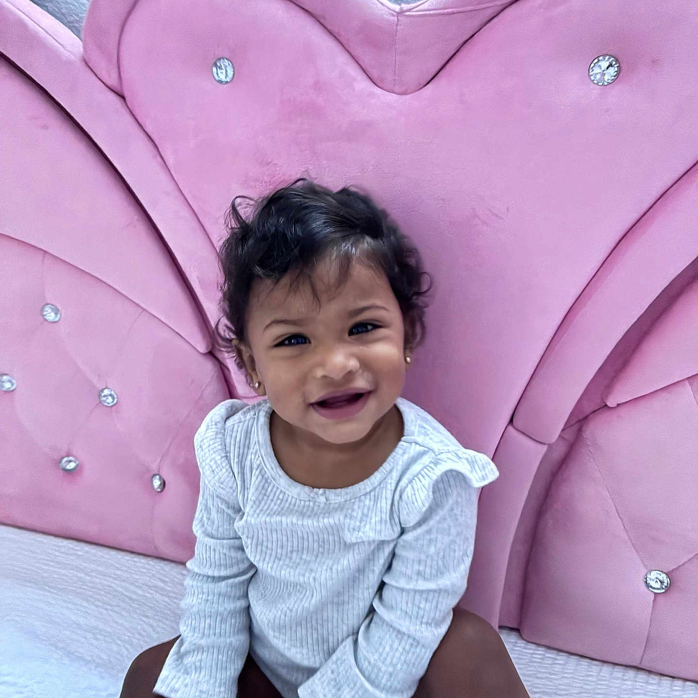 Zamira joined the competition — help win amazing prizes! toddler, child, smiling, sitting, portrait, indoors, pink, chair, upholstery, sparkles, gray_clothing, long_sleeves, curly_hair, earrings, happy, baby, furniture, home, closeup, photography