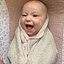baby, towel, smiling, happy, infant, wrapped, face, mouth_open, lying_down, skin, head, child, cute, expression, texture, blanket, cozy, human, newborn, cheerful