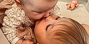 Lya participe au concours pour gagner de l'argent avec cette photo : baby, child, kiss, love, toddler, indoor, cuddle, family, affection, toy, carpet, furniture, wood, sibling, cute, person, face, skin, hair, earring