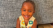 Nova joined the competition — help win amazing prizes! toddler, child, smiling, colorful_vest, white_dress, sitting, indoor, floor, happy, cute, portrait, face, person, earrings, texture, couch, wooden_floor, bright_eyes, joyful, young_child