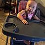 Skylar joined the competition — help win amazing prizes! baby, high_chair, child, indoor, pink_clothing, smiling, playful, furniture, floor, lamp, table, chair, tiled_floor, person, seat, hand, foot, cushion, expression, home