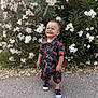 Eiden a rejoint le concours — aidez-le/la à gagner de superbes lots ! toddler, child, smiling, standing, outdoor, flowers, greenery, nature, shirt, shorts, footwear, path, plants, happy, cute, boy, summer, casual_clothing, leaves_pattern, daylight