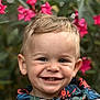 Eiden a rejoint le concours — aidez-le/la à gagner de superbes lots ! child, toddler, smile, face, blond_hair, blue_eyes, flower, pink_flower, green_leaves, nature, outdoor, portrait, happy, clothing, patterned_shirt, button, closeup, young_child, cute, headshot