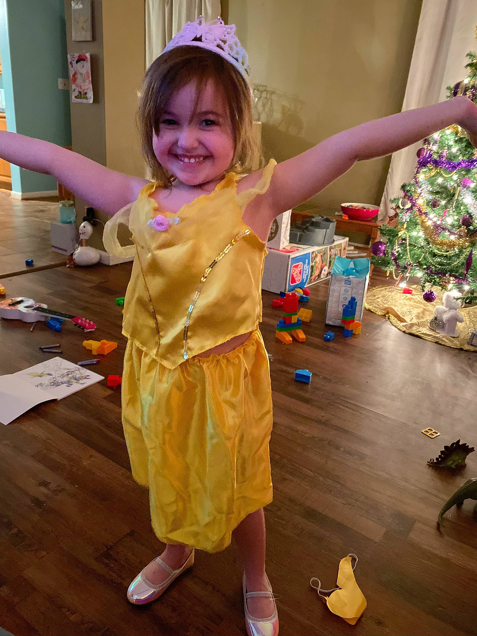 Adriana joined the competition — help win amazing prizes! child, christmas_tree, design, event, fashion_design, flooring, fun, happy, joy, party_supply, person, play, purple, sandal, smile, snapshot, standing, textile, toddler, white