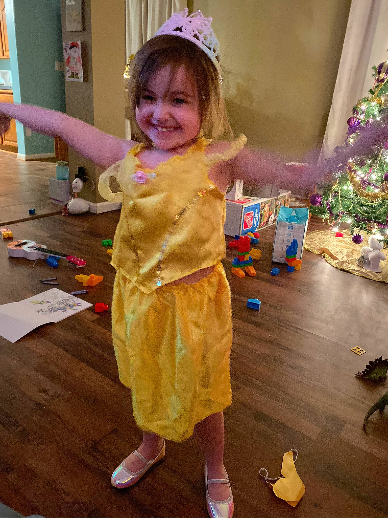 Adriana joined the competition — help win amazing prizes! child, christmas_tree, event, fashion_design, floor, flooring, fun, happy, hardwood, joy, leisure, party_supply, person, pink, play, purple, room, smile, snapshot, standing