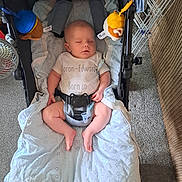 Aaron joined the competition — help win amazing prizes! baby, infant, stroller, blanket, sleeping, indoor, car_seat, toy, soft_toy, carpet, child, clothing, seatbelt, comfort, resting, peaceful, floor, fabric, nap, cushion