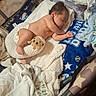 Lucas joined the competition — help win amazing prizes! baby, sleeping, diaper, plush_toy, blanket, playpen, star_pattern, baseball, soft_cushion, baby_clothes, infant, resting, cozy, indoors, newborn, child, peaceful, cute, toddler, nap