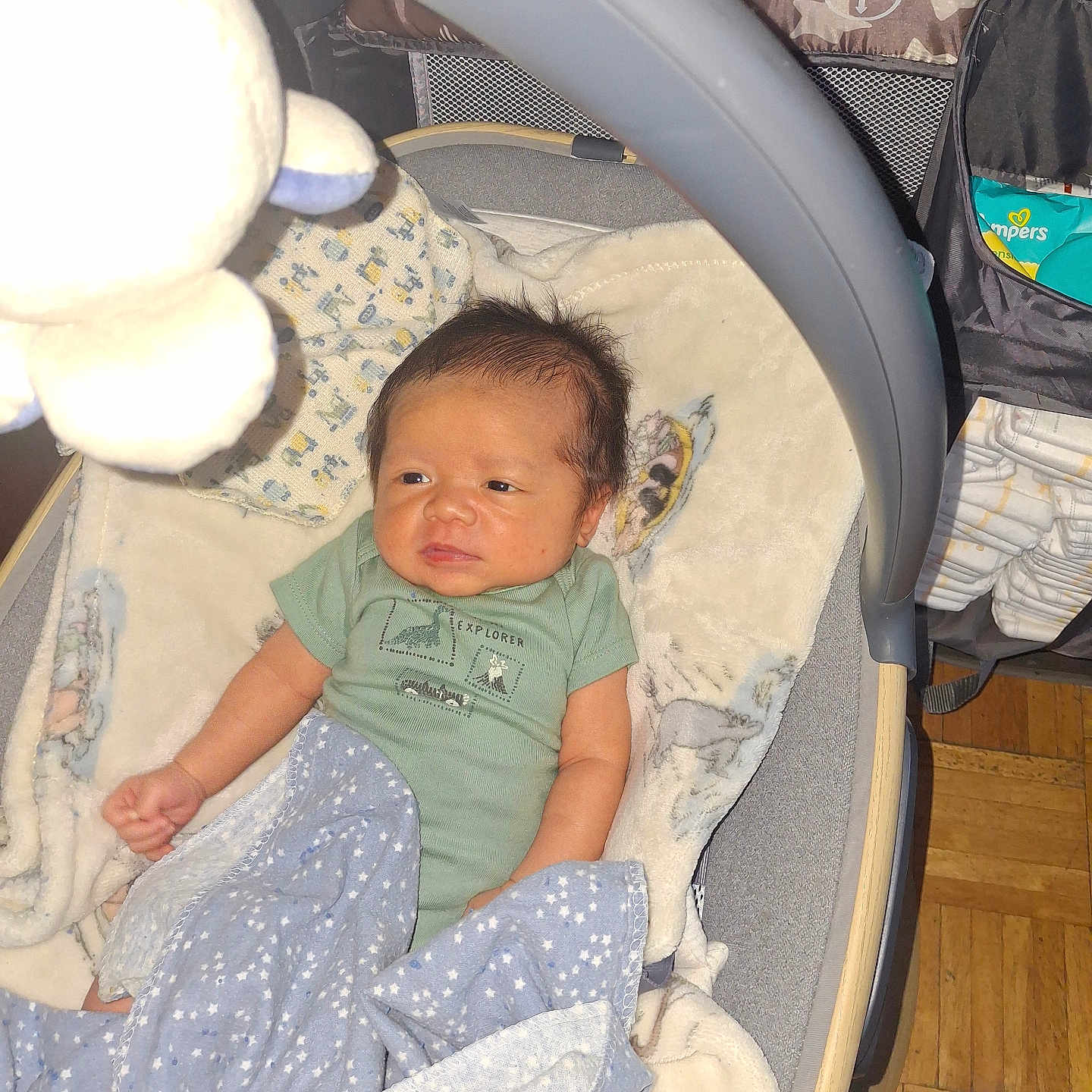 Lucas joined the competition — help win amazing prizes! baby, infant, blanket, bassinet, plush_toy, toy, face, clothing, wooden_floor, diapers, storage_organizer, sleeping_area, cute, indoor, child, newborn, fabric, soft, person, small
