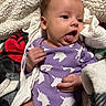 Alani joined the competition — help win amazing prizes! baby, infant, purple_onesie, unicorn_pattern, tongue_out, blanket, cozy, cute, sleepwear, newborn, hand, face, skin, lying_down, soft, clothing, comfort, child, resting, cute_expression
