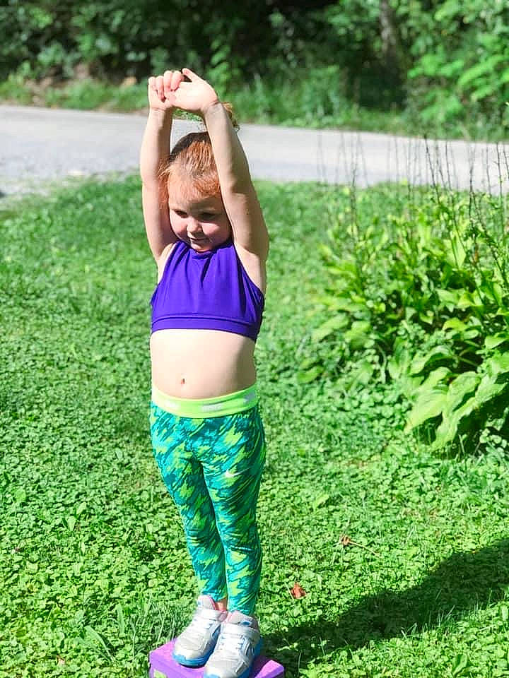 Zelda is registered to the contest to win money with this photo: abdomen, active_pants, exercise, footwear, grass, grassland, green, happy, knee, leisure, meadow, people_in_nature, person, plant, sportswear, street_fashion, t_shirt, thigh, trunk, waist