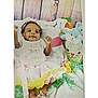 Alayah is registered to the contest to win money with this photo: baby, infant, child, smiling, easter, skirt, shirt, blanket, toys, bunny, basket, decorations, feet, happy, headband, wooden_background, colorful, celebration, cute, lying_down