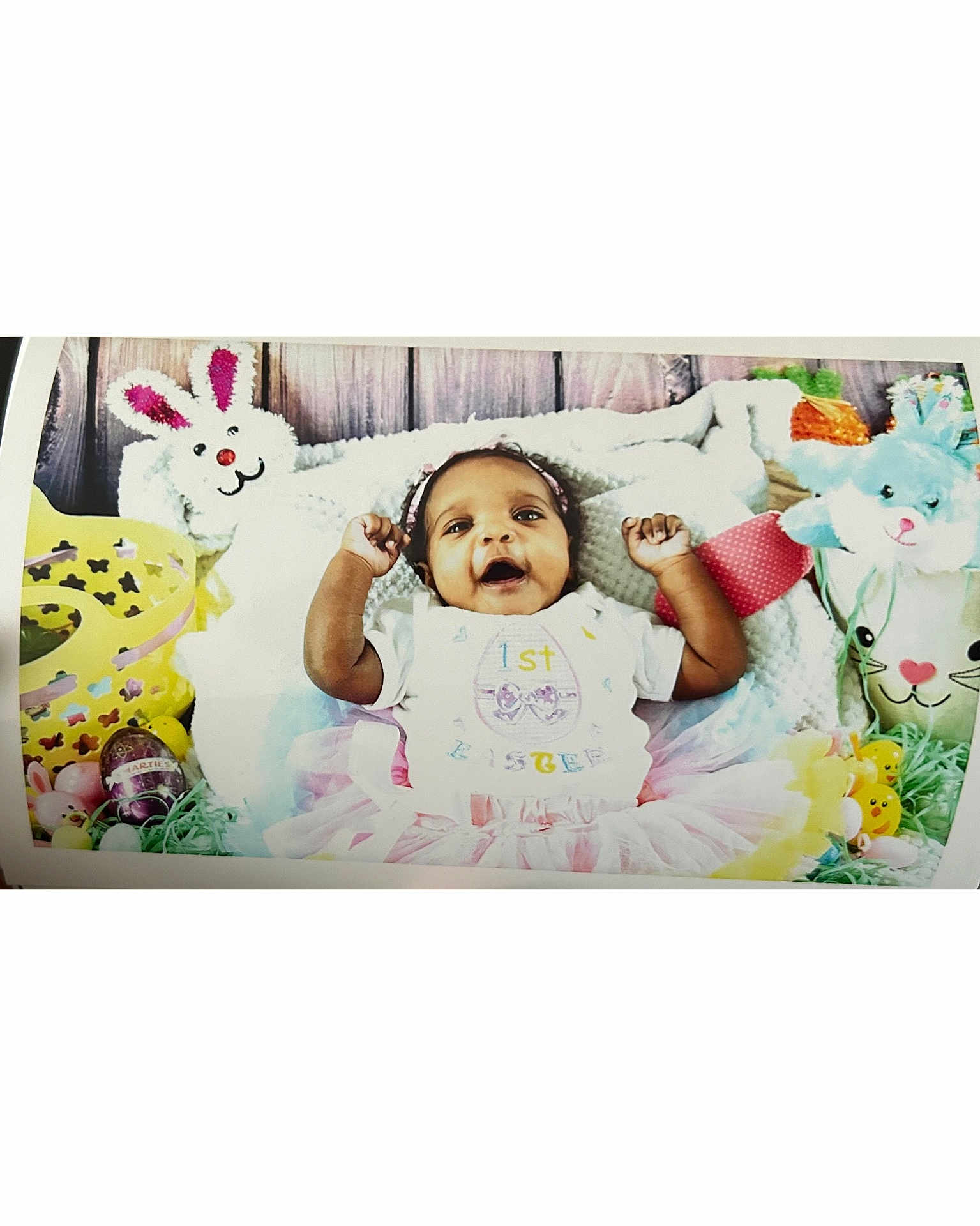 Alayah joined the competition — help win amazing prizes! baby, child, easter, plush_bunny, stuffed_animal, easter_egg, holiday, celebration, smiling, tutu, headband, colorful, decorations, basket, grass, wooden_background, cute, infant, happy, portrait