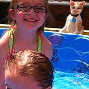 Otis joined the competition — help win amazing prizes! child, children, girl, baby, pool, water, summer, outdoor, sunlight, glasses, cat, pet, play, happy, smile, hair, blue, fun, vacation, family