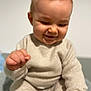 baby, child, smiling, knitwear, beige_clothing, sitting, soft_focus, indoor, portrait, cute, infant, happy, young_child, sweater, pants, person, skin, head, hand, face