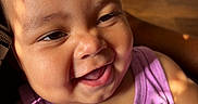 Leyah Swink is registered to the contest to win money with this photo: baby, smile, face, child, portrait, indoor, tank_top, purple_clothing, sunlight, shadow, cute, happy, infant, closeup, person, skin, hair, expression, joy, warm_light