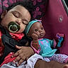 toddler, sleeping, pacifier, doll, car_seat, butterfly_pattern, child, toy, cute, baby_clothes, pink, blue, hand, foot, curly_hair, seatbelt, indoor, rest, peaceful, infant