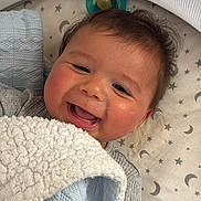 Ayaz is registered to the contest to win money with this photo: baby, smiling, blanket, pacifier, face, infant, cozy, blue, white, pattern, stars, moon, mesh, canopy, bed, cute, happy, sleeping_area, clothing, portrait