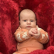 Paisley Marie Taylor joined the competition — help win amazing prizes! baby, blanket, child, clothing, cozy, cute, expression, face, floral_pattern, hands, indoors, infant, lying_down, pajamas, person, portrait, red_blanket, skin, soft_texture, young_child