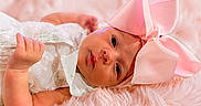 Brylee is registered to the contest to win money with this photo: adorable, baby, child, closeup, cute, expression, face, fluffy_blanket, headwear, indoors, infant, lying_down, newborn, peaceful, pink_bow, portrait, skin, small_hand, soft_texture, white_dress