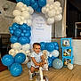 balance_bike, balloons, birthday, blocks, blue, celebration, child, cute, decor, event, floor, happy, indoor, party, person, riding, smile, toddler, toy, white