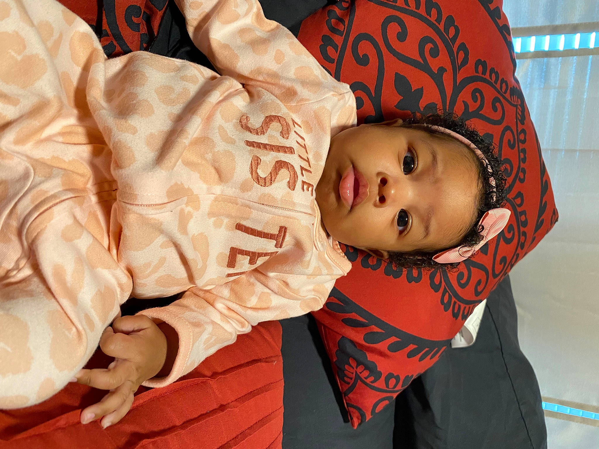 Zaniyah is registered to the contest to win money with this photo: baby, baby_toddler_clothing, carmine, cheek, child, comfort, eye, eyelash, fun, hat, headgear, human_body, mouth, orange, outerwear, person, room, skin, sleeve, toddler