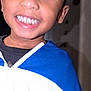 Nasir is registered to the contest to win money with this photo: child, smile, face, close_up, jacket, blue, white, indoor, happy, teeth, young, portrait, person, casual, clothing, kid, expression, joy, head, eyelashes