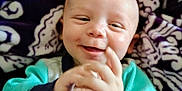Remington joined the competition — help win amazing prizes! baby, smiling, happy, clapping, infant, face, child, blanket, pattern, cozy, cute, portrait, clothing, hand, skin, indoor, expression, young, head, comfort