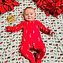 Remington joined the competition — help win amazing prizes! baby, infant, red_onesie, candy_cane, blanket, woodland_animals, poinsettia, holiday, milestone, smiling, lying_down, cute, face, child, christmas, decor, soft_texture, four_months, plush, festive