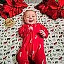 baby, infant, smiling, red_clothing, candy_cane_pattern, blanket, woodland_animals, poinsettia, flower, milestone_sign, four_months, holiday_theme, cute, lying_down, happy, tongue_out, festive, indoors, portrait, child